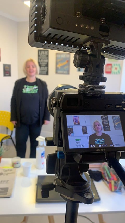 Professional video camera recording woman